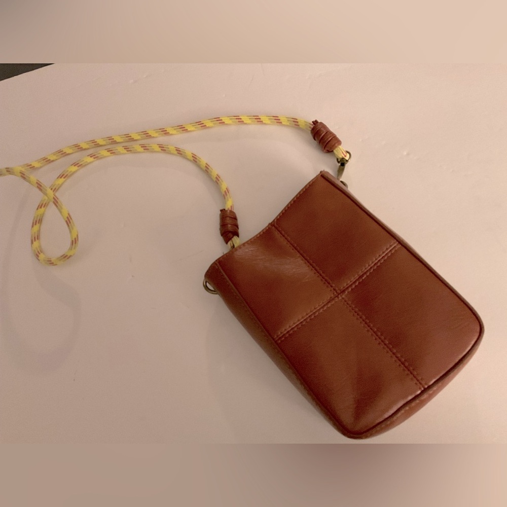 Brown small crossbody. Can hold lip gloss, keys, ID etc.